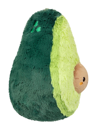 Side view of a plush avocado, its face, which is the pit, sticking out on the right.