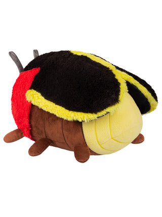 Back angle view of a yellow, brown, red and black plush firefly.