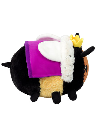 Side view of a plush version of a queen bee, with a purple robe and little yellow crown.