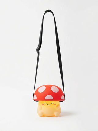 A squishy silicone mushroom lamp hanging off a black lanyard.