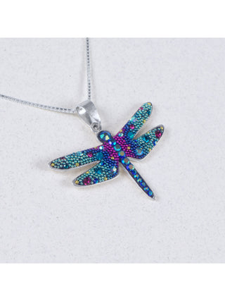 A bedazzled pendant in the shape of a dragonfly on a silver chain.