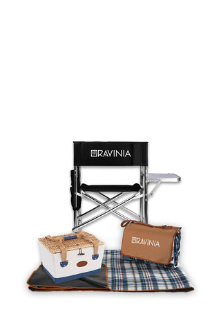 A black sports chair, a white picnic basket, and a plaid ground blanket in front of a white background.