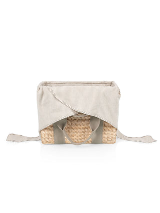 The Ravinia woven picnic basket, with the interior fabric lining untied and open.