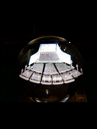 A close-up of the detailed Pavilion blueprint, lit from the base underneath, on a dark background.