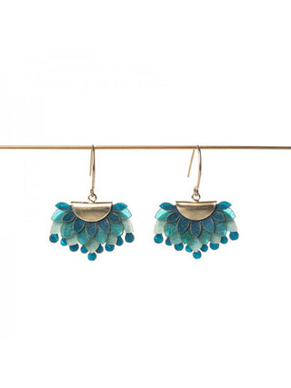 A pair of brass and blue earrings made of drum leather.