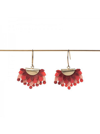 A pair of brass and red earrings made of drum leather.