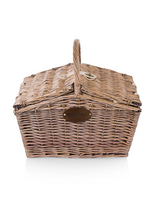A wicker picnic basket with a brown leather plate with the Ravinia logo.