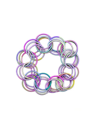 A bracelet made of multiple interlocking multicolored loops of piano wire.