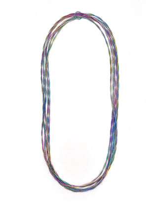 Five long strands of twisted rainbow-colored piano wire, held together with a loop.