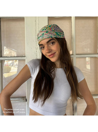 A model in a white shirt wearing a Sari Chic Bandana wrapped around her head.