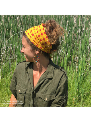 A model in a green shirt with a Sari Chic Bandana holding back their hair.