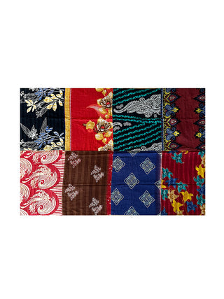 A colorful patchwork sari blanket with different patterns, laid out to show different designs.
