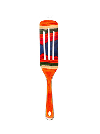 A colorful wooden slotted kitchen utensil, on a white background.
