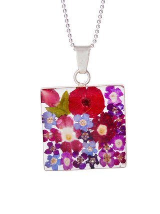 A square resin pendant made with various fresh wildflowers, encased in sterling silver.
