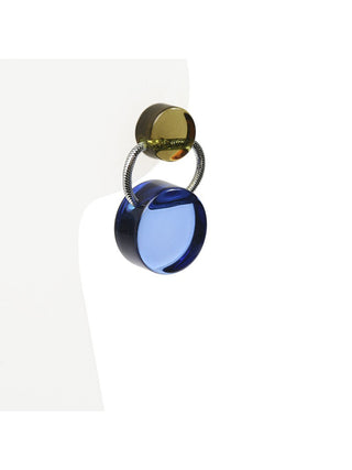 A post earring with two colorful acrylic components and metallic elastic thread, on a display.