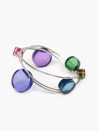 A bracelet made of colorful acrylic discs on silver elastic threads.