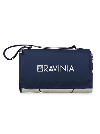 A navy blue picnic blanket with the Ravinia logo, rolled compactly with a carrying strap.
