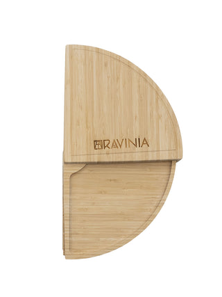 A bamboo cheese board with the Ravinia logo in the shape of a half circle.