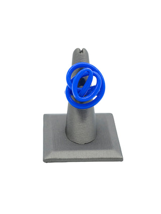 A blue squiggle ring on a gray ring display.