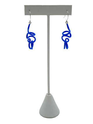 Blue twisty earrings hanging on a white earring holder.