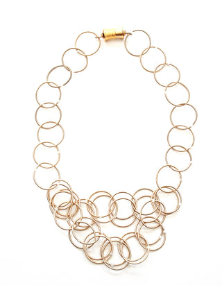 Champagne loops of piano wire adorned with moonstone form a necklace, with a magnetic clasp.