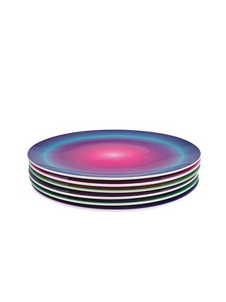 A stack of six plates. The one on the top is brightly colored with a concentric circular pattern.