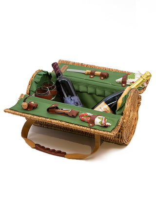A cylindrical basket, open to reveal a green felt interior with two wine bottles, wine glasses, cheese knife, cork, napkins and other picnic accessories.