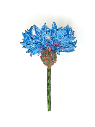 A sequined brooch in the form of a blue cornflower.