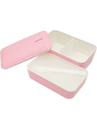 A pink rectangular box, open, with the lid on the left and the two white interior sections on the right. The section at the top has a spacer in the middle, and the one at the bottom has a white plastic fork in it.