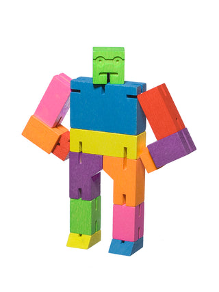 A multicolored wooden robot with his arms on his hips, his green head looking straight ahead.