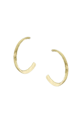 Brass-toned circular post earrings with texture visible.
