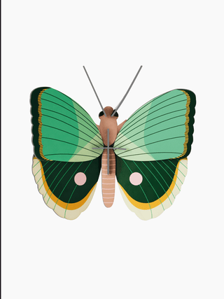 A cardboard butterfly with a brown body and two shades of green on its wings.