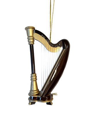 An ornament that looks exactly like a black and gold harp, with a gold cord for hanging.