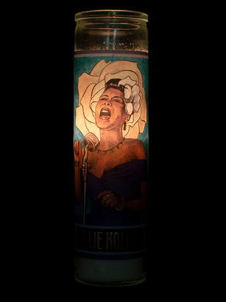 A lit votive with an illustration of Billie Holiday on it.