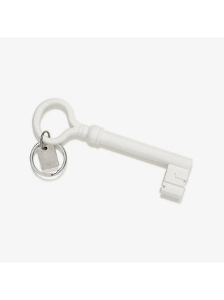 A large white skeleton key with keychain attached.