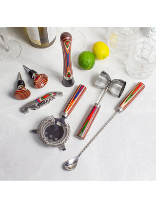 A seven piece bartenting set, each piece sporting a vibrantly colored handle, with a lemon and lime above them.