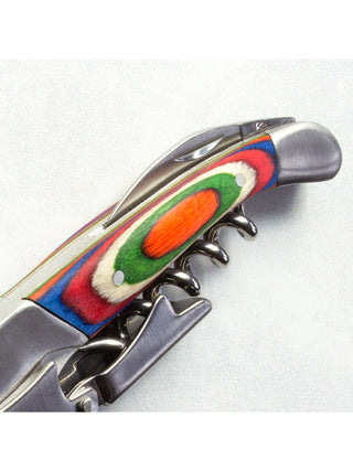 The vibrantly colored handle of a corkscrew and bottle opener.