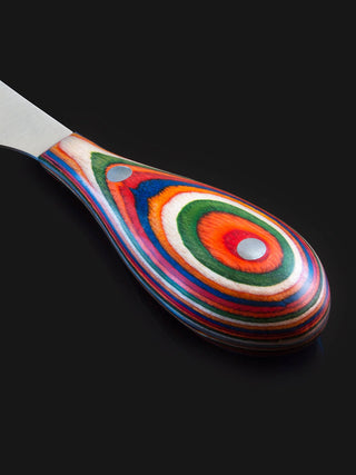 A vibrantly colored handle of a cheese knife.