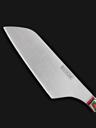 The sharp, straight stainless steel blade of a cheese knife.