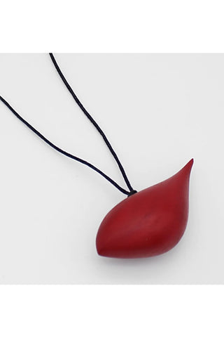 Close-up view of a red wooden bird pendant hanging on an adjustable black wax cord.