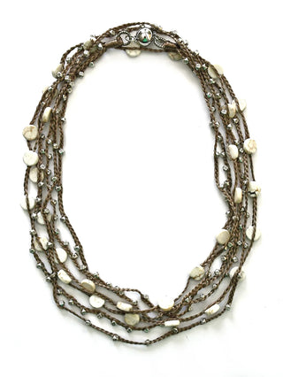 A doubled silk twine necklace adorned with silver-toned beads and white turquoise buttons.