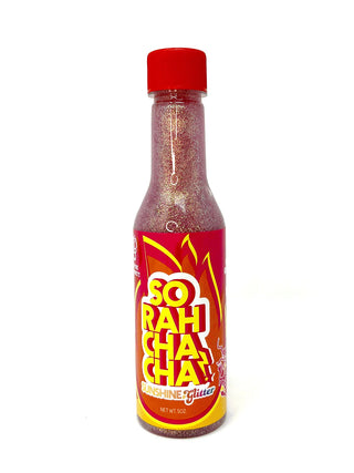 A bottle that looks like hot sauce, with red glitter inside and a label that reads, So Rah Cha Cha.