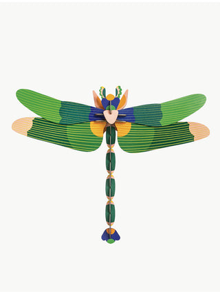 An overhead view of a large, cardboard dragonfly in green with blue accents.