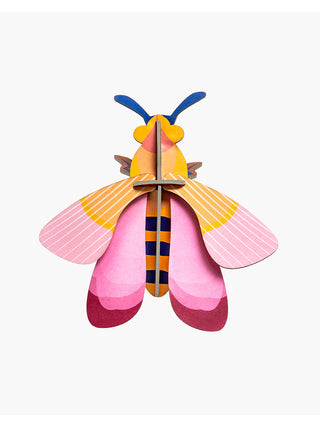 A pink and orange cardboard bee with blue antenna.